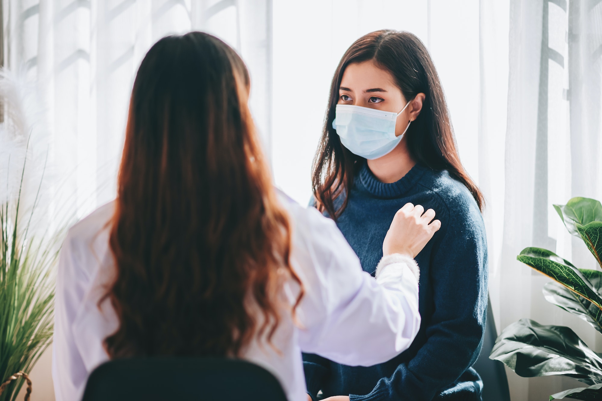 Asian doctor visit and examines on young adult woman at hospital with office syndrome and depression
