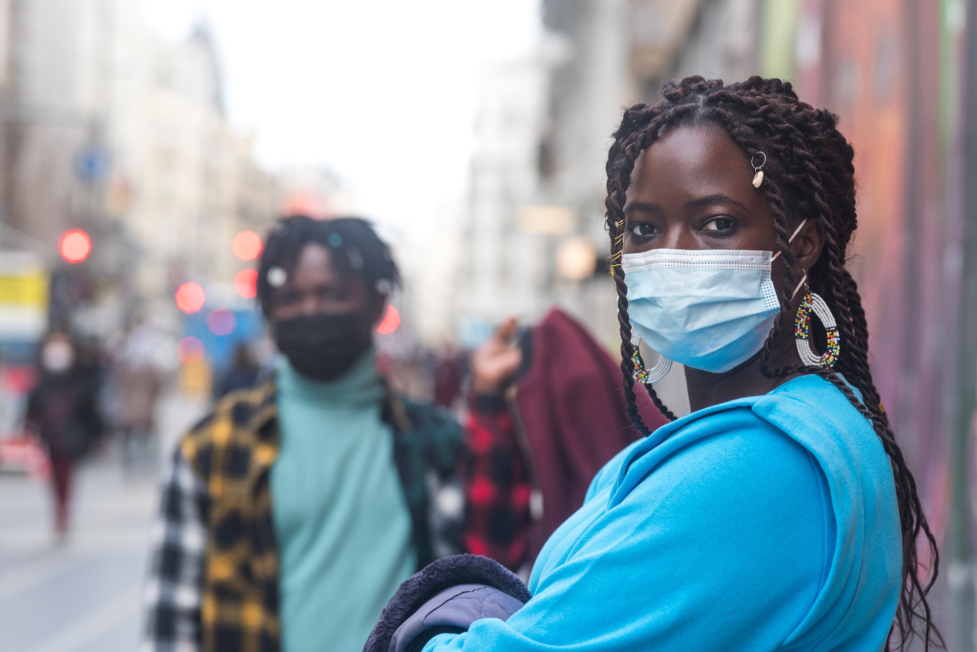 Black couple in the city. With masks.