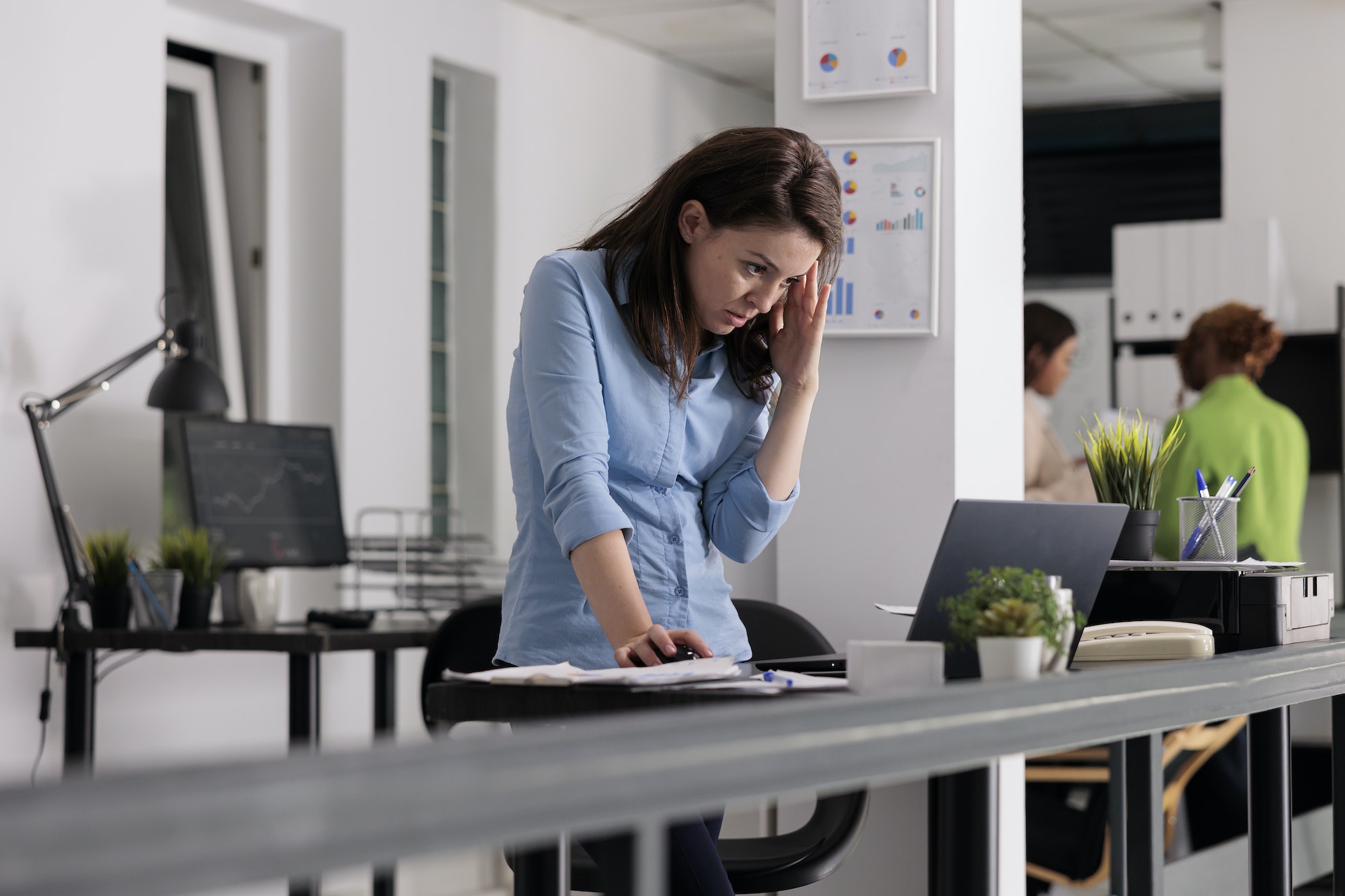 Sad employee having headache, busy manager tired from work