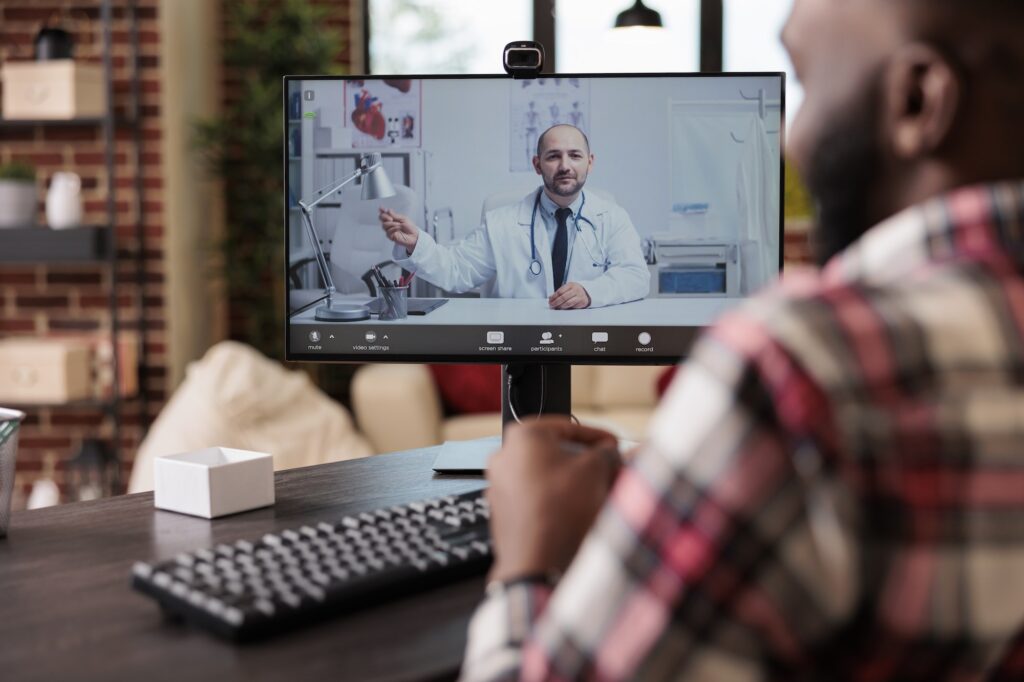 Adult talking to medic on telehealth videocall