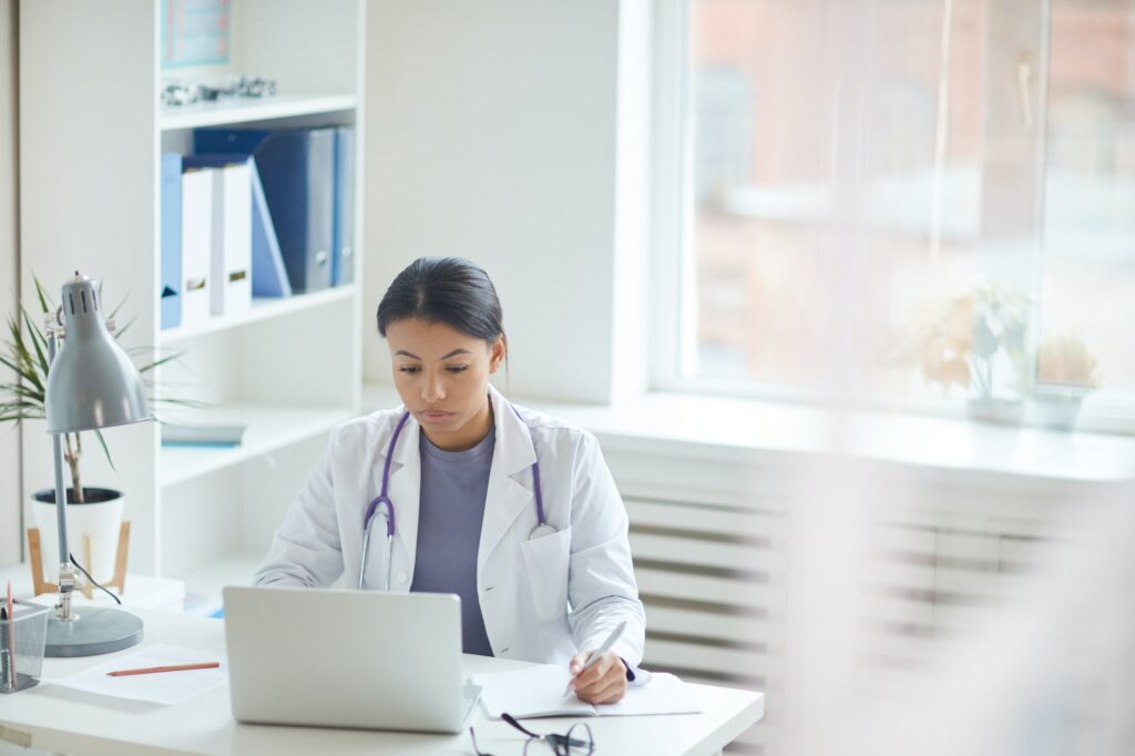 Doctor using laptop at office